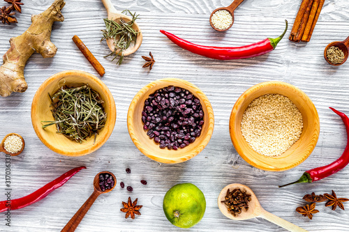 Dry colorful spices, chili pepper on kitchen light table background top view