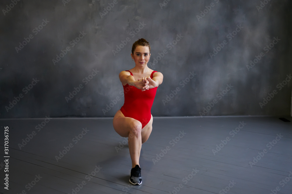 Peaceful woman doing lunges exercise training in studio