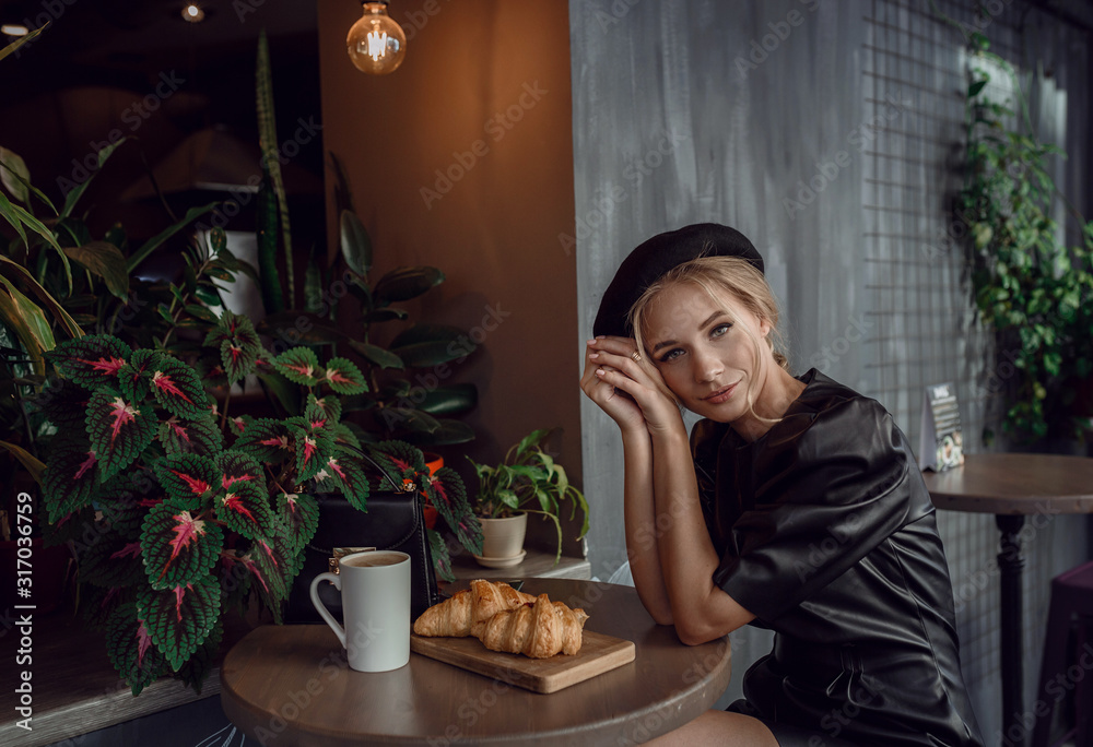 Young elegant woman drinking coffee in traditional cafe in Paris, France Young elegant woman drinking coffee in traditional cafe in Paris, France