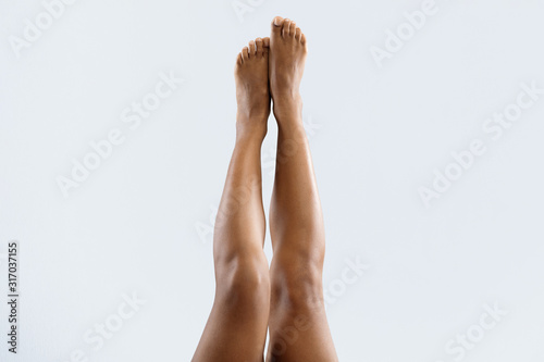 Beautiful afro woman lifting her legs up in air