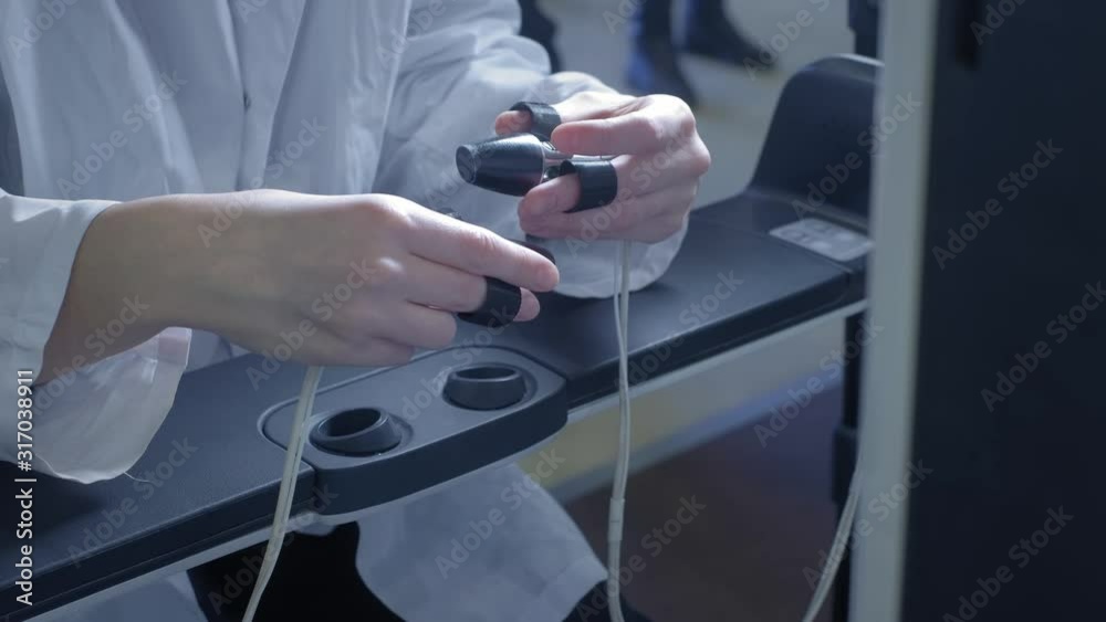 A girl surgeon performs an operation on a patient in virtual reality. Manages the arms of the robotic arms. New technologies in medicine, innovations. Remote treatment of cancer patients and infected. A girl surgeon performs an operation on a patient in virtual reality. Manages the arms of the robotic arms. New technologies in medicine, innovations. Remote treatment of cancer patients and infected.