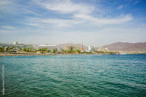 summer time vacation season destination Middle East Israeli city Eilat on Red sea bay Gulf of Aqaba port hotel district waterfront side with water foreground, copy space for your text © Артём Князь