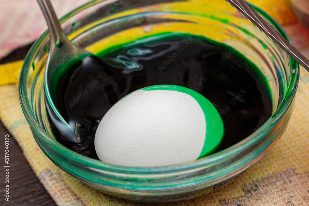 Painting, dying green eggs for Easter in glass jar Painting, dying green eggs for Easter in glass jar