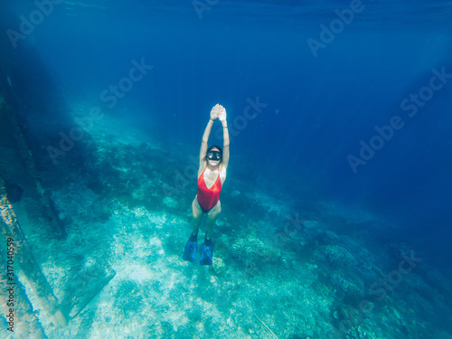 Getaway journey to tropical island with crystal blue oceania with coral reef for discover sea depth during snorkeling scuba diving, woman enjoying swim hobby during summer recreation holidays