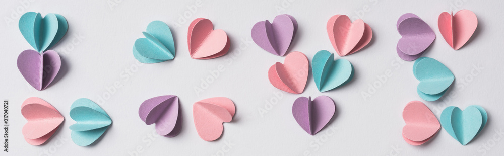 top view of love lettering made of colorful paper hearts on white background, panoramic shot