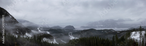 Beautiful Panoramic View of the Canadian Mountain Nature Landscape during a cloudy and foggy rainy morning. Taken near Squamish, North of Vancouver, BC, Canada.