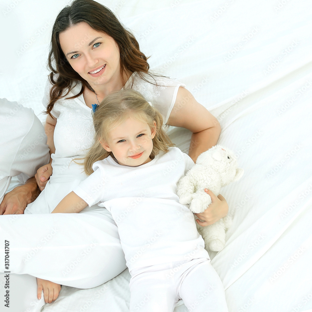 portrait of a happy family on the bed in the bedroom portrait of a happy family on the bed in the bedroom