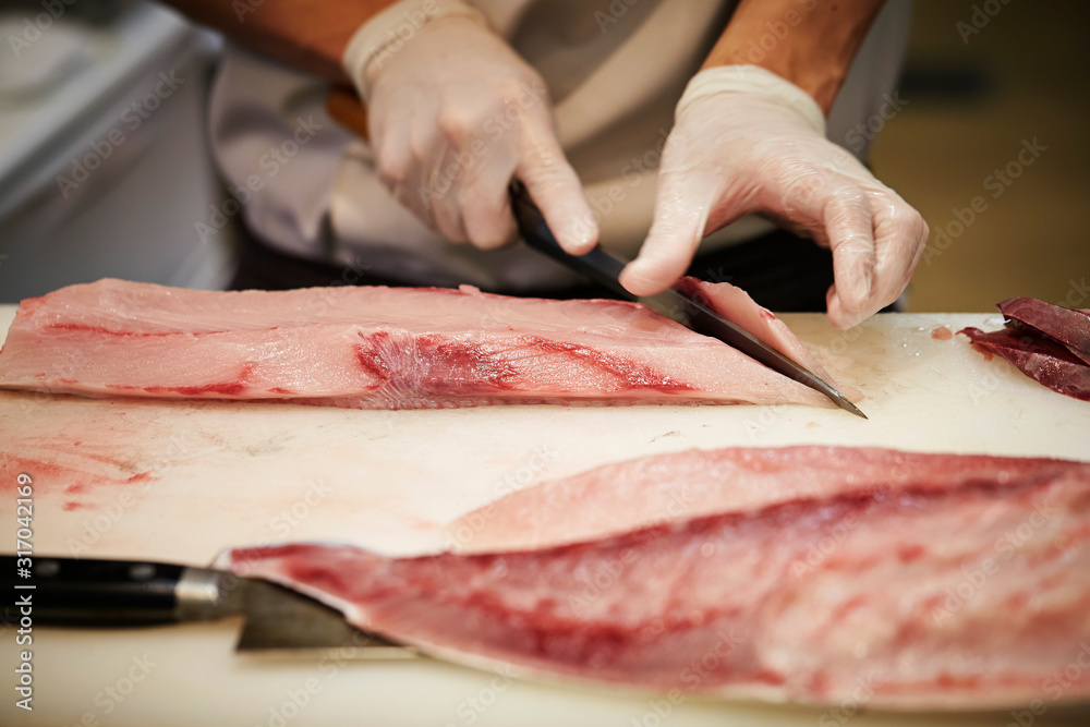 Filleting fish at fish market 