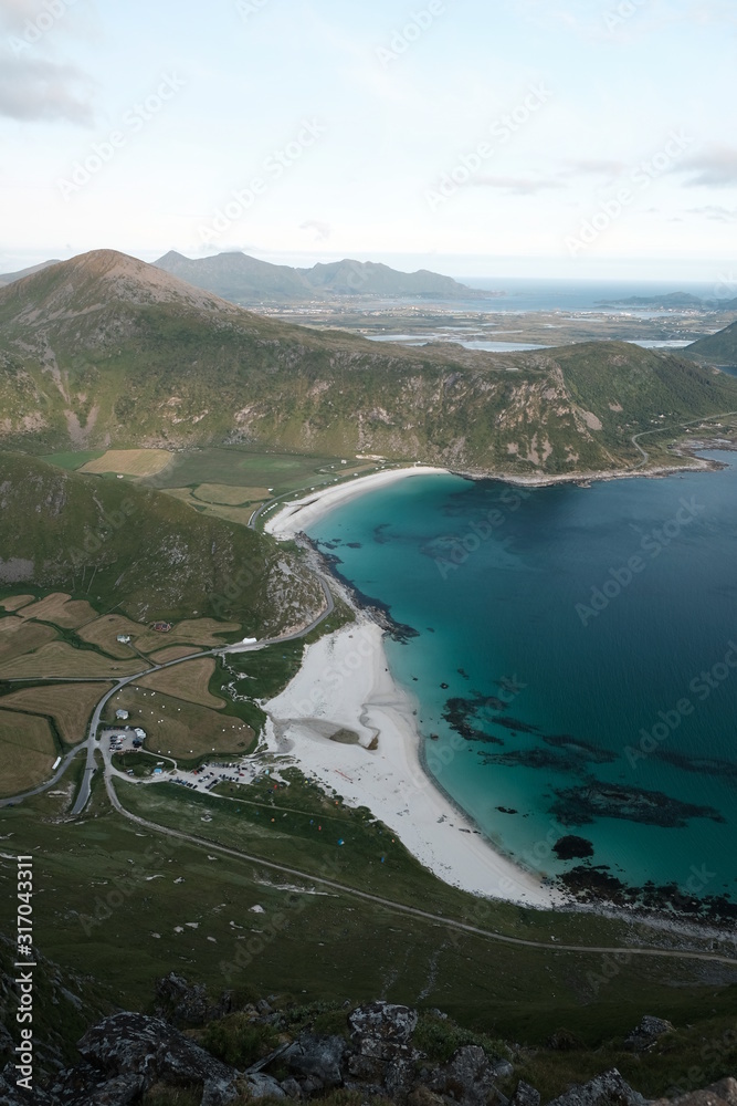 Naklejka premium Hakland beach view from Mannen mountain in Lofoten islands, which is a famous hike. The best view in Lofoten. trekking from the beach to mountain. turquoise sea and sunset.