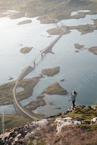 a view from Volandstinden  mountain in Lofoten islands in north of Norway..famous kubholmenleia bridge  photo