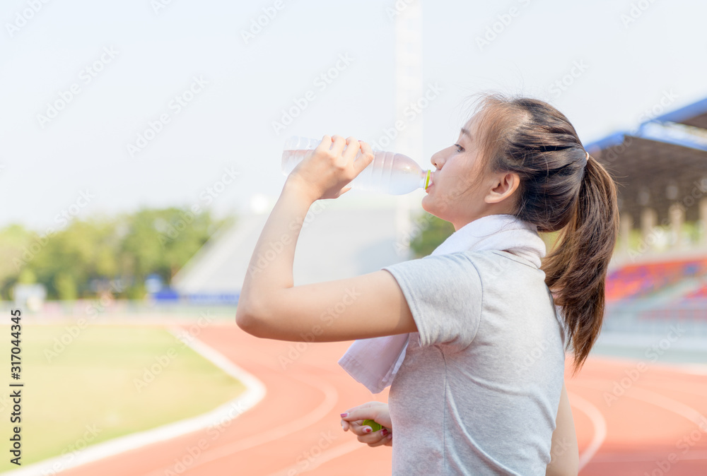 Beautiful asian athlete woman drinking water from bottle Beautiful asian athlete woman drinking water from bottle