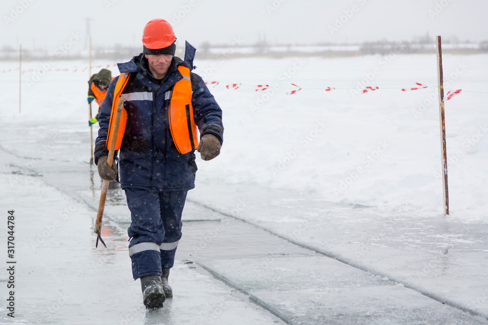 Workers rafting ice blocks along a channel cut out by a frozen lake Workers rafting ice blocks along a channel cut out by a frozen lake