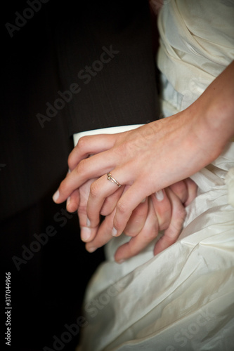 Wedding couple, bride and groom, holding hands during the ceremony