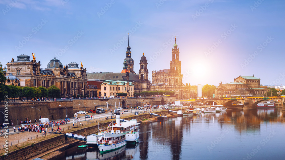 Fototapeta premium Incredible evening panorama of Cathedral of the Holy Trinity or Hofkirche, Bruehl's Terrace or The Balcony of Europe. Dramatic autumn sunset on Elbe river in Dresden, Saxony, Germany, Europe.