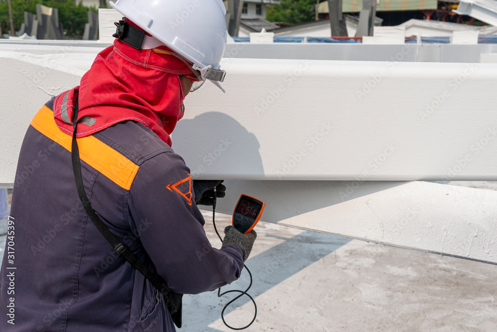 Technicians are measuring the Dry Film Thickness (DFT) with Coating