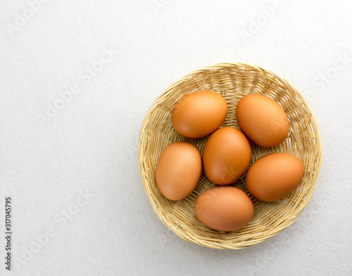 Obraz na płótnie Eggs placed in a woven wooden basket. w salonie