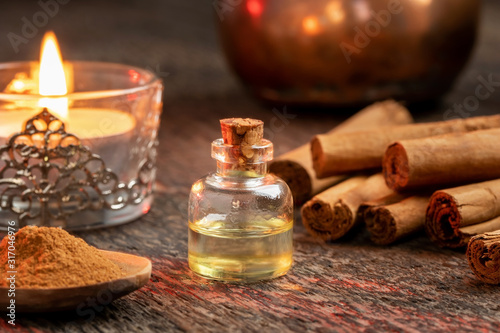 A bottle of cinnamon essential oil with true cinnamon