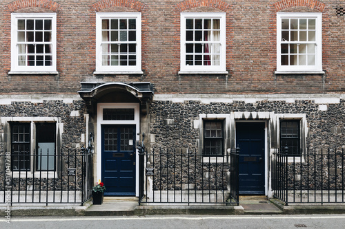 Typical street scene in the central London district with familiar architecture facades to urban housing.