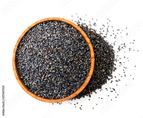 Bild auf Leinwand Poppy seeds in a wooden plate close-up view from above. Isolated
