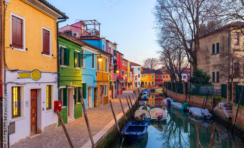 Lovely house facade and colorful walls in Burano, Venice. Burano island canal, colorful houses and boats, Venice landmark, Italy. Europe © daliu