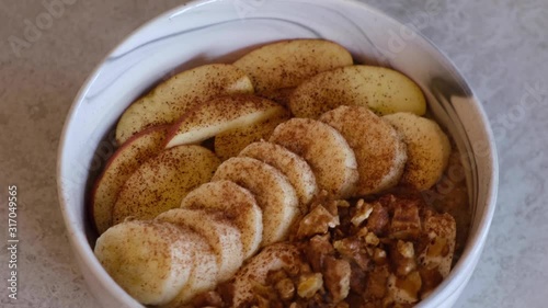 Baked porridge with bananas, blueberries, walnuts, raisins and sunflower seeds. Healthy vegan breakfast. Slow motion.