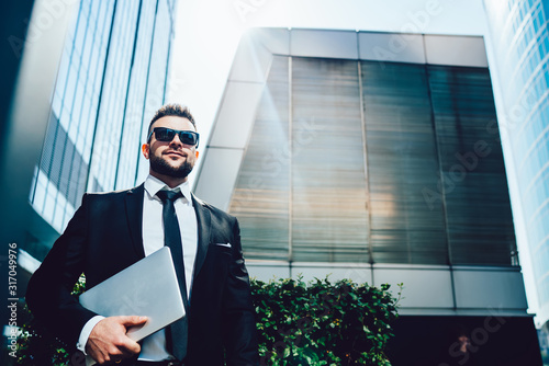 Happy determined businessman on street in downtown