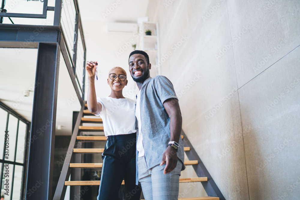 Cheerful black couple receiving home key