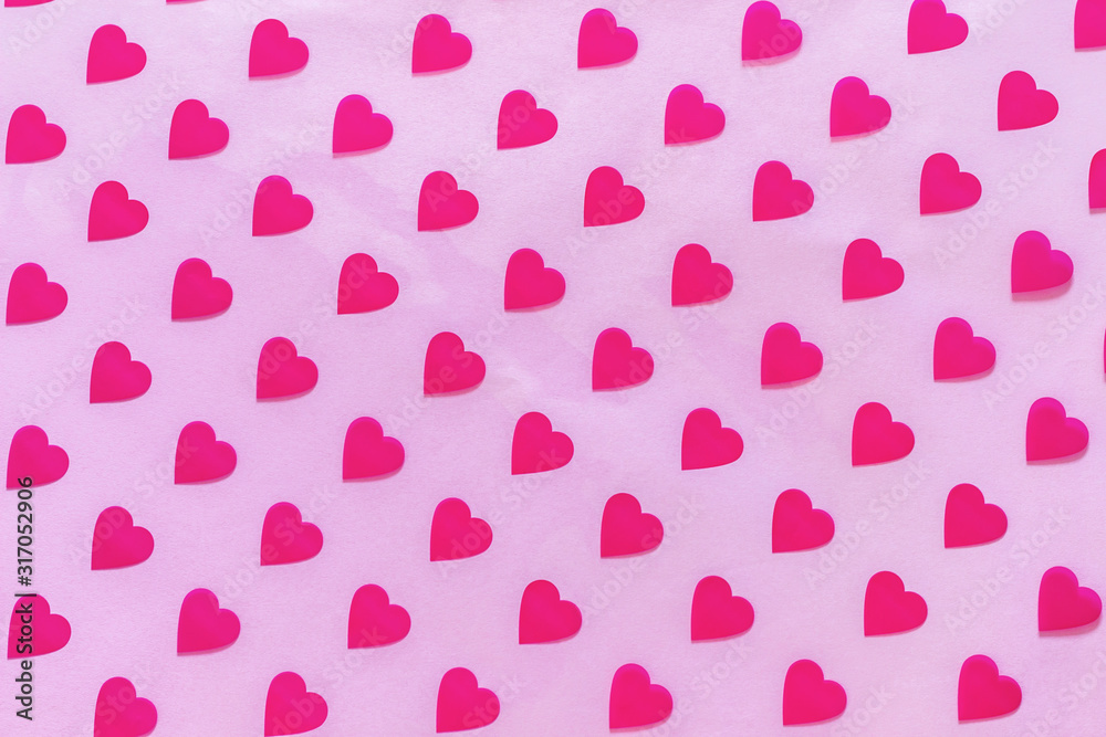 Pattern made of hearts on pink background. Abstract love, St. Valentine's day backdrop. Top view, soft focus.