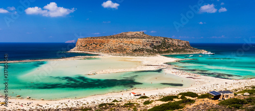 Fantastic panorama of Balos Lagoon and Gramvousa island on Crete, Greece. Cap tigani in the center. Balos beach on Crete island, Greece. Tourists relax and bath in crystal clear water of Balos beach.