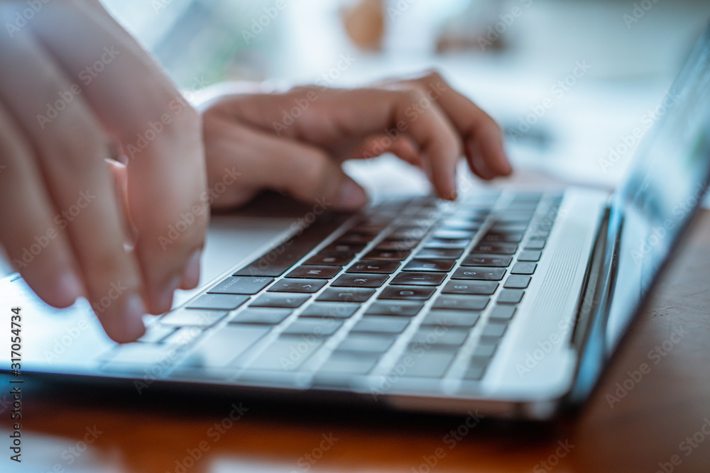 A male Hands typing on notebook laptop A male Hands typing on notebook laptop