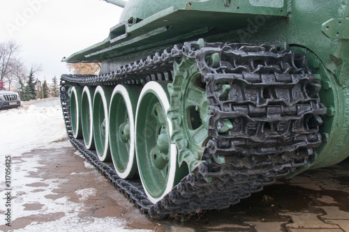 Black tank caterpillar with green wheels. Museum of military equipment.
