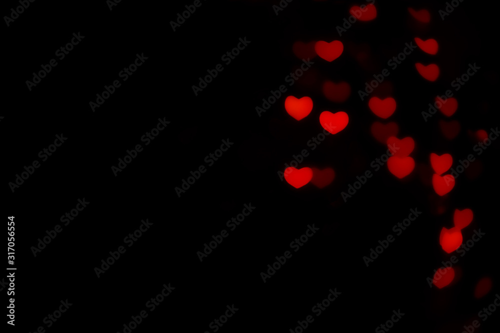Abstract beautiful romantic picture of blur brightness red colored of swirling heart shaped bokeh on black from ornamental lights flickering. Background for Valentine’s day or Love or Romance concept. Abstract beautiful romantic picture of blur brightness red colored of swirling heart shaped bokeh on black from ornamental lights flickering. Background for Valentine’s day or Love or Romance concept.