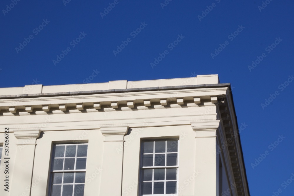 Traditional white building against deep blue sky