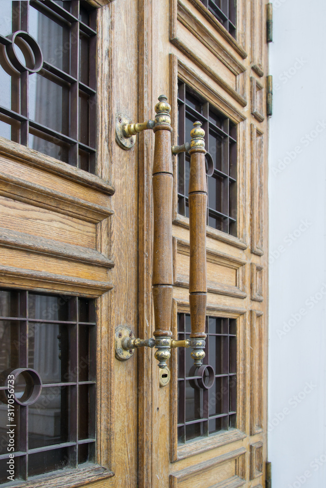 Long wooden door handles of a modern temple