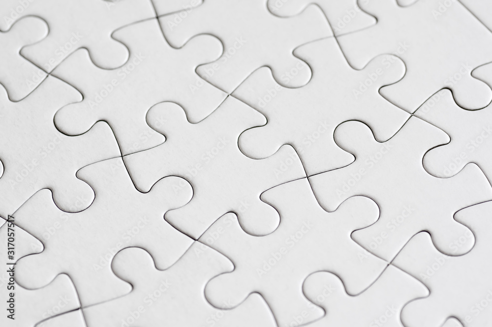 Close up on white blank jigsaw puzzle Close up on white blank jigsaw puzzle