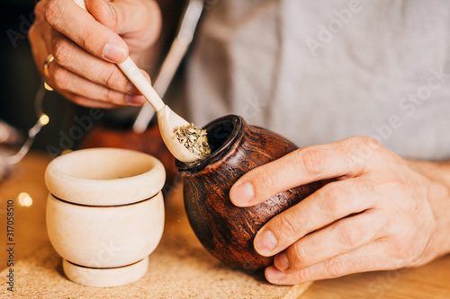 Making yerba mate in calabash - a traditional South American drink