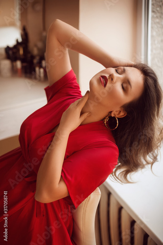 Portrait of beautiful young woman with makeup in fashion red clothes