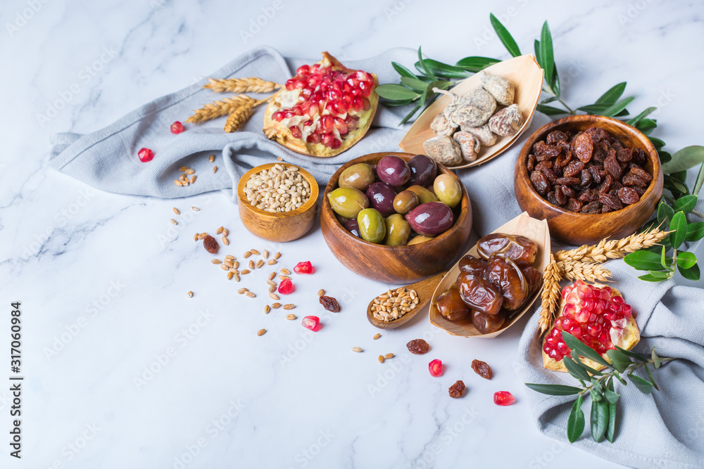 Fototapeta premium Tu Bishvat holiday symbols - dried fruits, pomegranate, barley, wheat