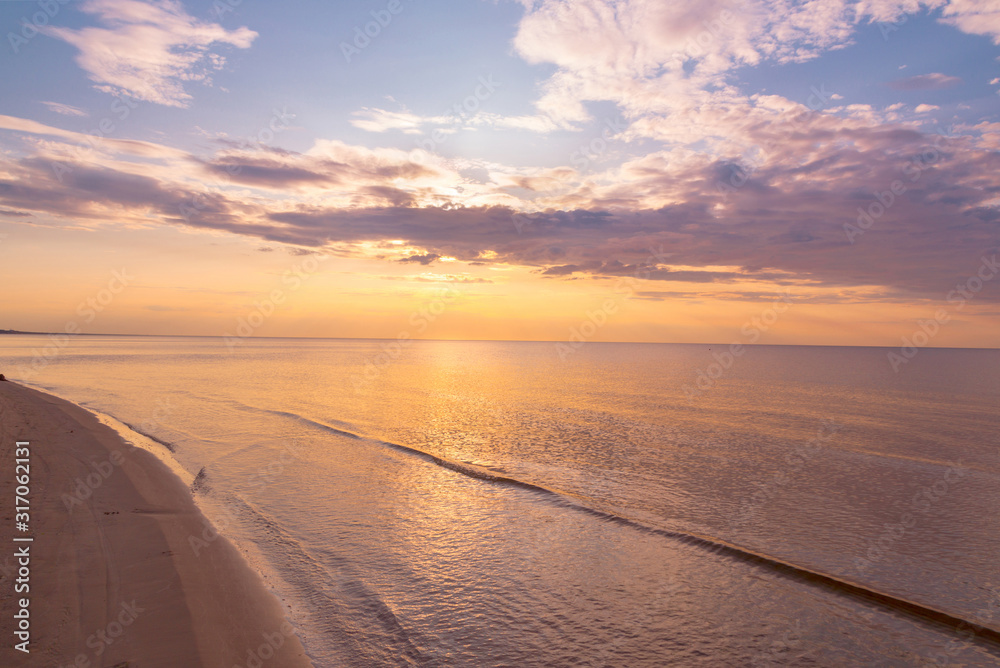 Beautiful sunset sky with clouds over Baltic sea beach coastline. Jurmala. Latvia.
