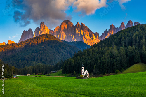 Landscapes with San Giovanni Church and small village in Val di Funes, Dolomite Alps, South Tyrol, Italy, Europe. San Giovanni in Ranui church (St John in Ranui church) in the Dolomites, Italy.
