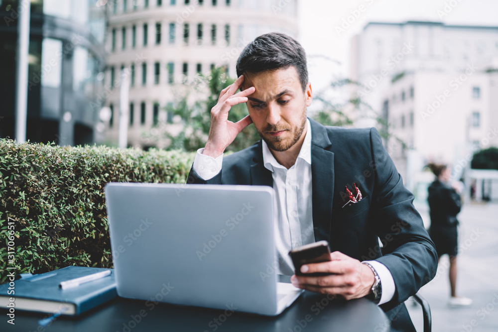 Pensive businessman thinking about project in cafe terrace Pensive businessman thinking about project in cafe terrace