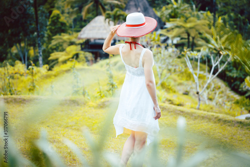Woman in tropical vacation walking through the jungle © Kzenon