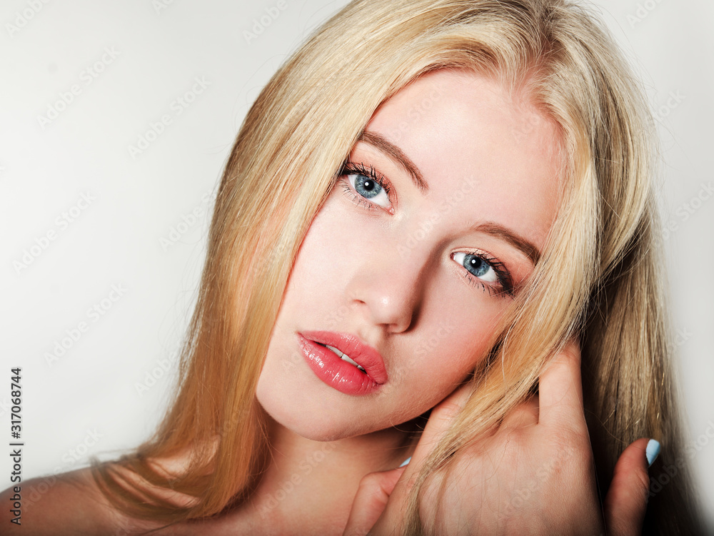 Portrait of beautiful blonde young woman face. Spa model girl with fresh clean skin isolated on a white background Portrait of beautiful blonde young woman face. Spa model girl with fresh clean skin isolated on a white background