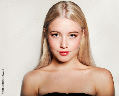 Portrait of beautiful blonde young woman face.  Spa model girl with fresh clean skin isolated on a white background