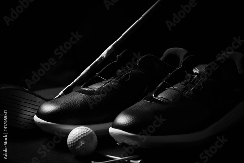 Golf shoes on isolated black background.