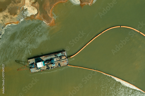 A dredger working in the quarry for sand mining. Aerial view