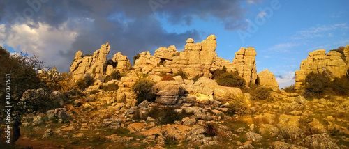 Panorama view on beautiful limestone formations in the impressive karst landscape of El Torcal de Antequera at sunset, Spain, Europe