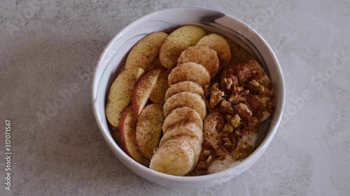 Baked porridge with bananas, blueberries, walnuts, raisins and sunflower seeds. Healthy vegan breakfast. Slow motion.