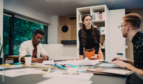 Multiethnic colleagues working at table in office