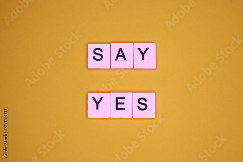 Say yes, on a yellow background. Motivational poster